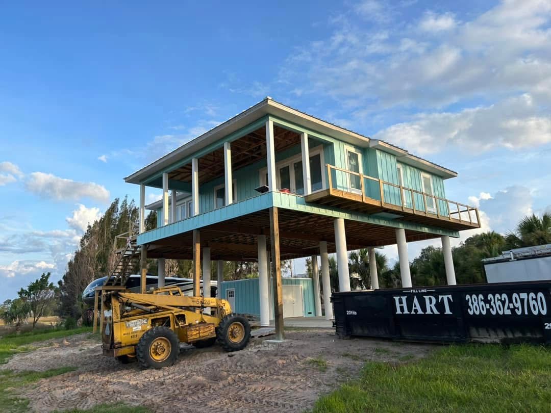 Elevated teal home exterior painted by Crawford Quest Painting